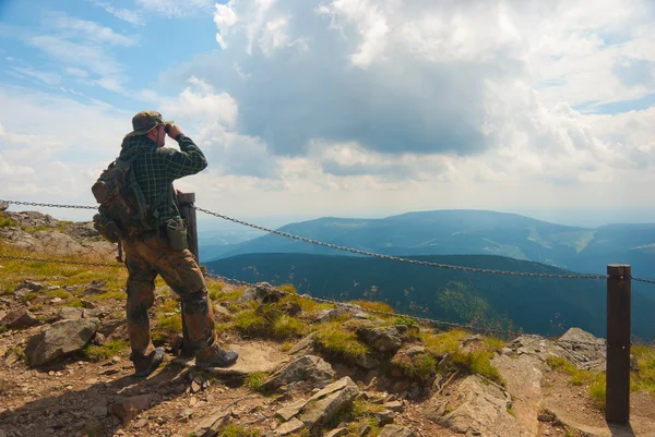 Hiker stands on a peak — Stock Photo, Image