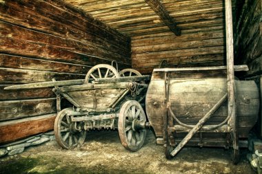 Old cart left in a wooden barn - vintage version clipart