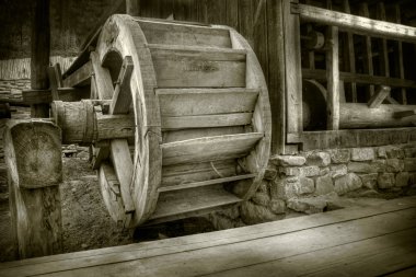 Antique waterwheel in a romanian village clipart