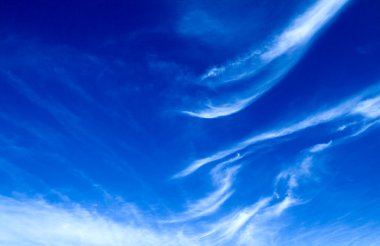 Intense blue sky with nice peaceful clouds clipart