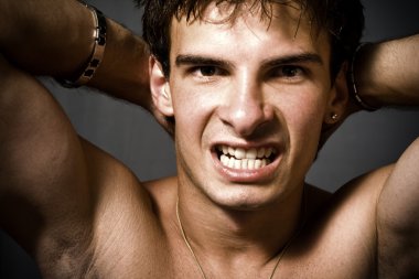 Portrait of wild sexy man showing his aggressive side clipart