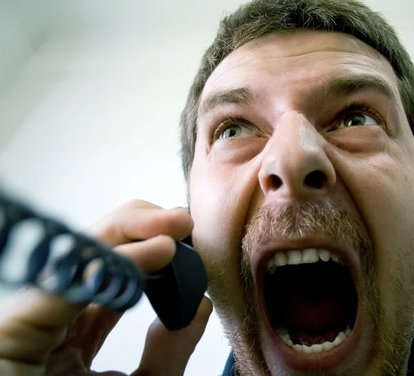 Angry stressed businessman at the phone — Stock Photo, Image