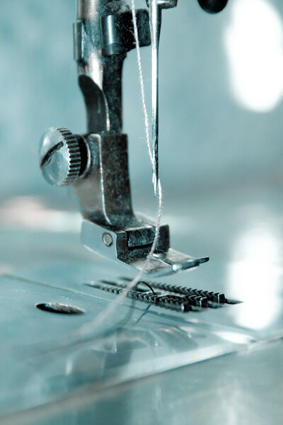 Macro view of sewing machine needle