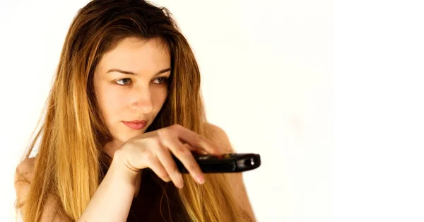 Zapping concept - young woman and remote control — Stock Photo, Image