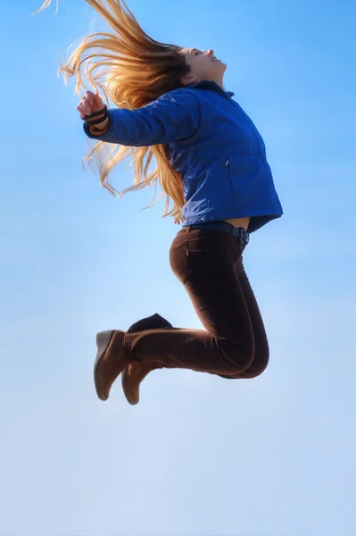 Mutlu Kız Atlama Mavi Gökyüzü Arka Plan Olarak — Stok fotoğraf