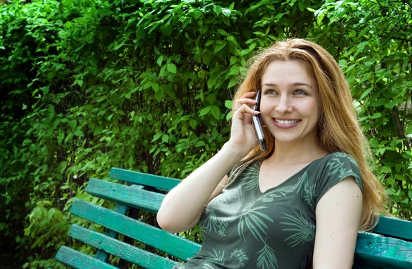 Beautiful young woman talking at the phone — Stock Photo, Image