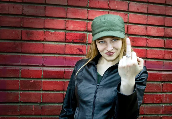 Young woman showing middle finger — Stock Photo, Image