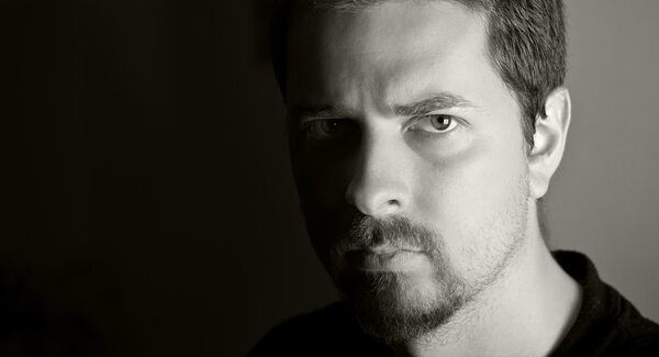 Low-key portrait of attractive young man (bw version)