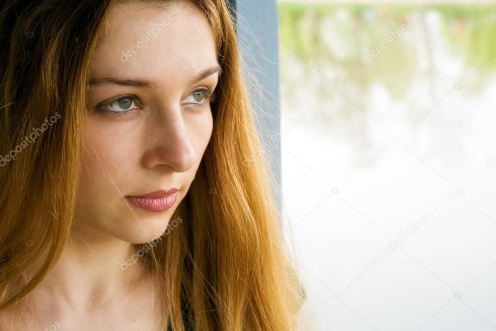 Beautiful young woman thinking about something
