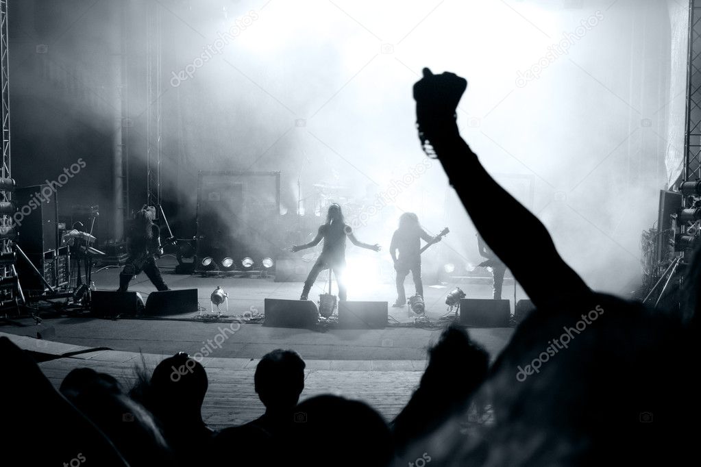 Scene from a rock concert with silhouette singer