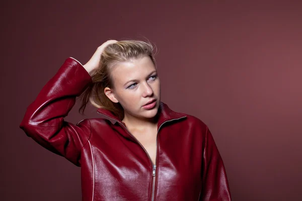 Sensual woman in a red leather jacket — Stock Photo, Image