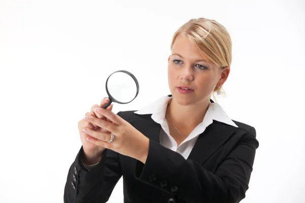 Business woman with a magnifier — Stock Photo, Image