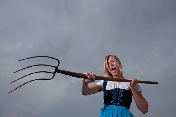 Angry bavarian girl with a pitchfork — Stock Photo, Image