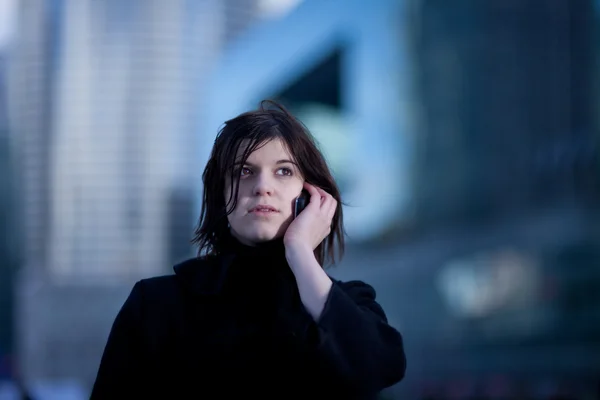 stock image Young woman talking on a cell phone outdoor