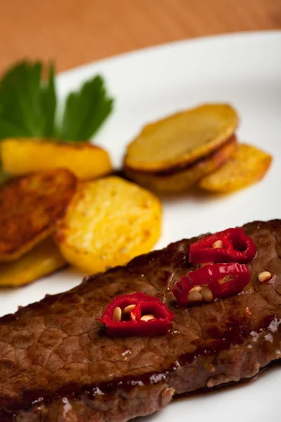 Slices o chili on a steak — Stock Photo, Image