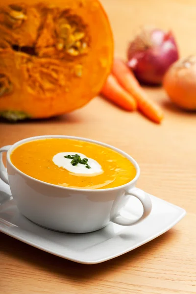 Pumpkin soup in a white bowl — Stock Image Pumpkin soup in a white bowl Royalty Free Stock Images
