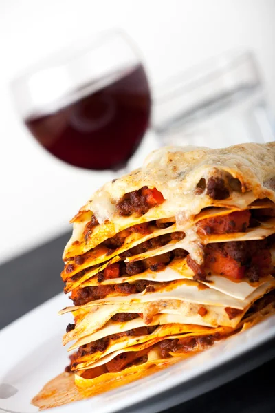 stock image Closeup of lasagna with red wine