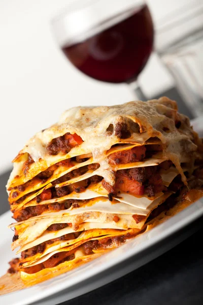 stock image closeup of lasagna with red wine