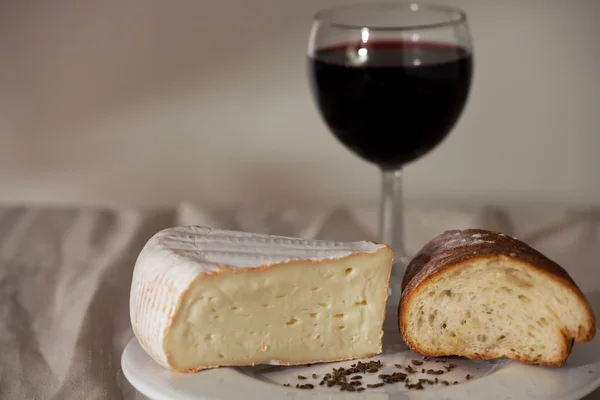 stock image Camembert cheese and a glass of wine