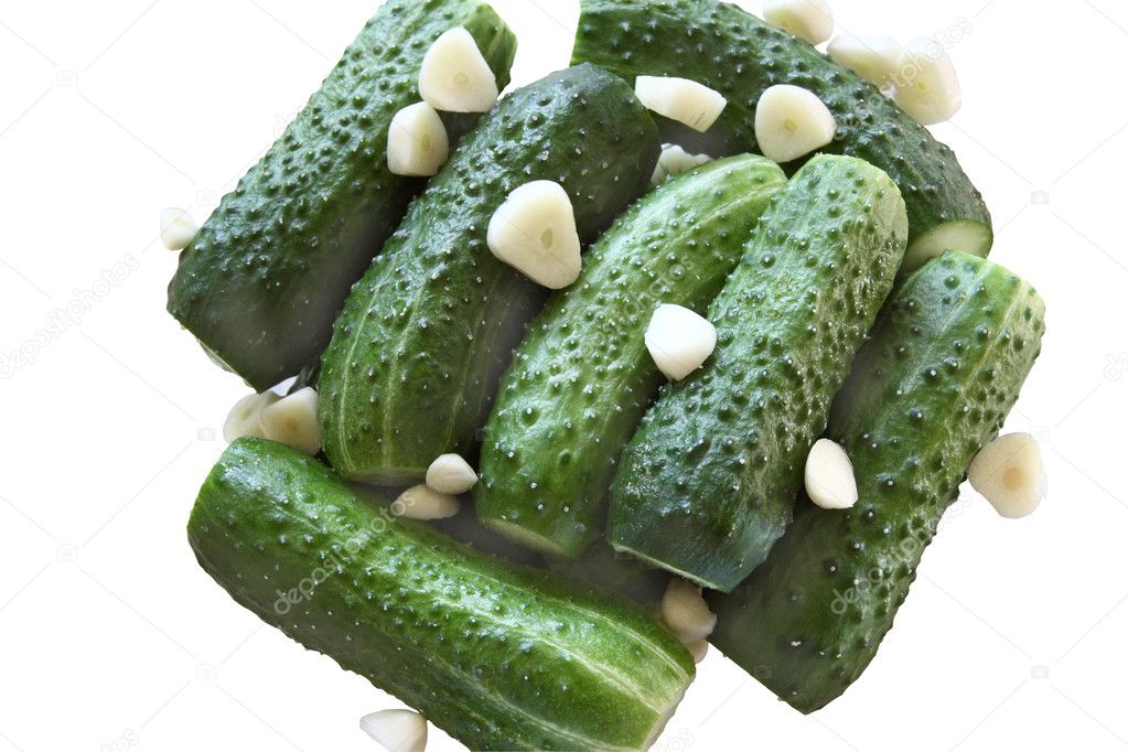 Fresh green cucumbers with sliced garlic
