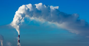 Smoking towers against the clear blue sky. clipart