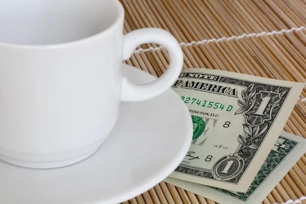 stock image Empty white cup and one dollar as tip.