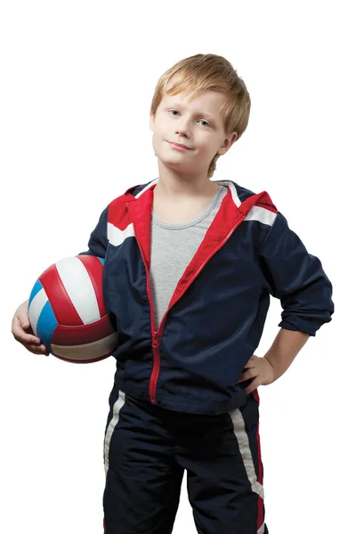 Den söta lilla pojken i en overall håller en boll — Stockfoto