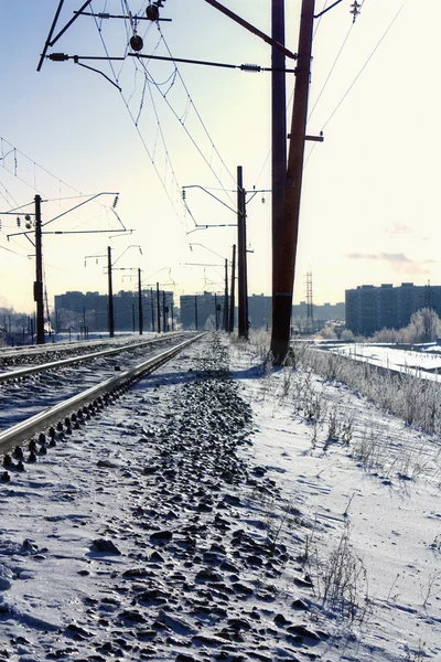 stock image View on a morning winter city. In the foreground rails.