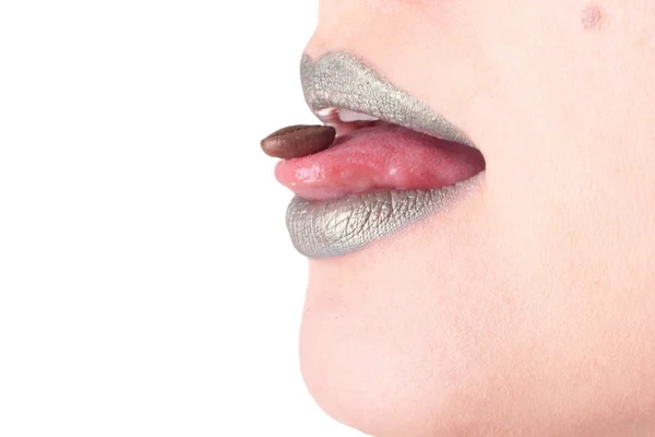 Closeup portrait of female lips with green makeup and a coffee seed — Stock Photo, Image