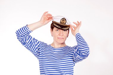 Middle aged female dressed as sailor in striped shirt and captain hat posin clipart