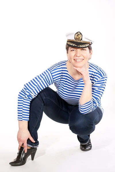 Middle aged female dressed as sailor in striped shirt and captain hat posin — Stock Photo, Image