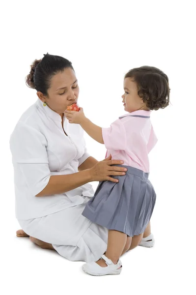 Cute girl feeding her mother — Stock Photo, Image