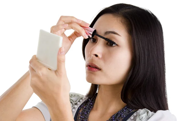 Young woman putting on black mascara — Stock Photo, Image