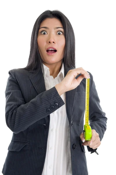 Surprised businesswoman with ruler — Stock Photo, Image
