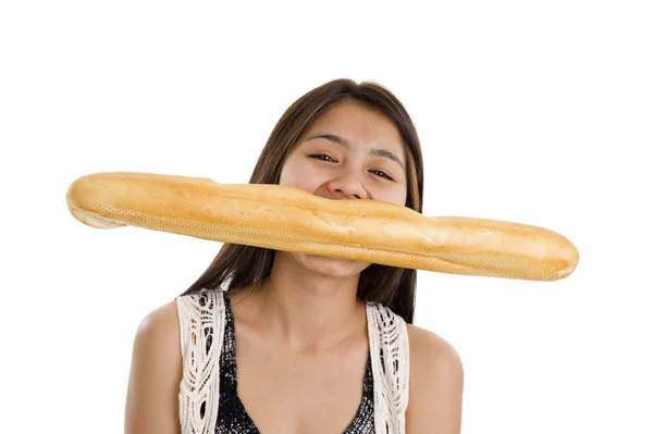 stock image Pretty asian woman biting in a french bread, isolated on white background