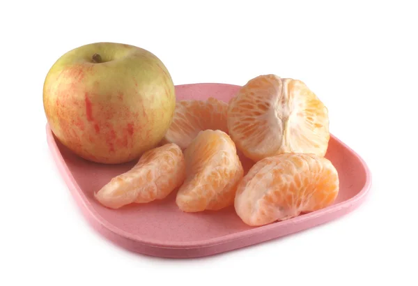 stock image Oranges and apple on a plate