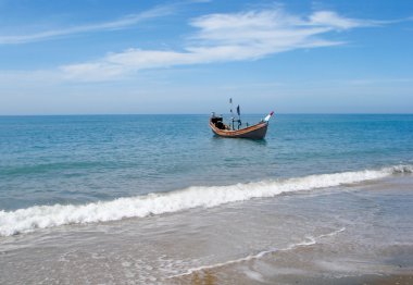 Wooden boat on a sea shore clipart