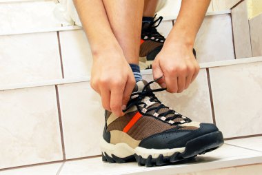 Boy tying his shoe clipart