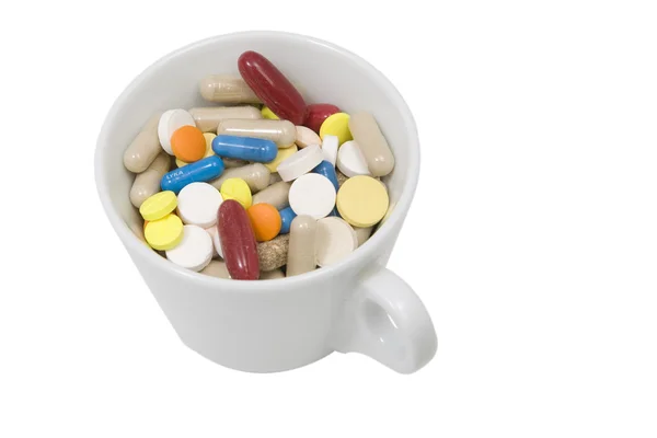 Cup of multicolored tablets and capsules — Stock Photo, Image