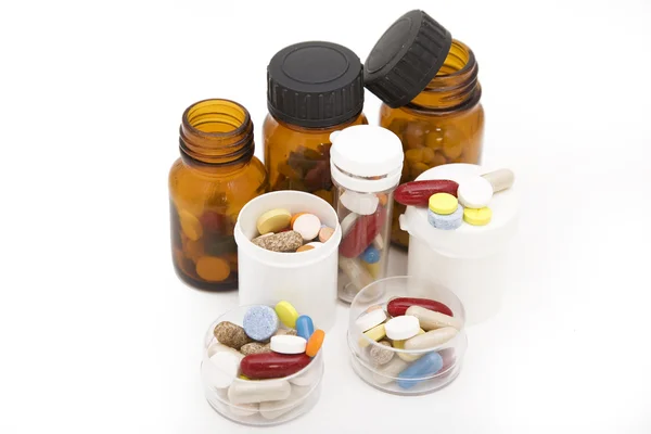 Fluxo colorido de pílulas e garrafas de pílulas — Fotografia de Stock