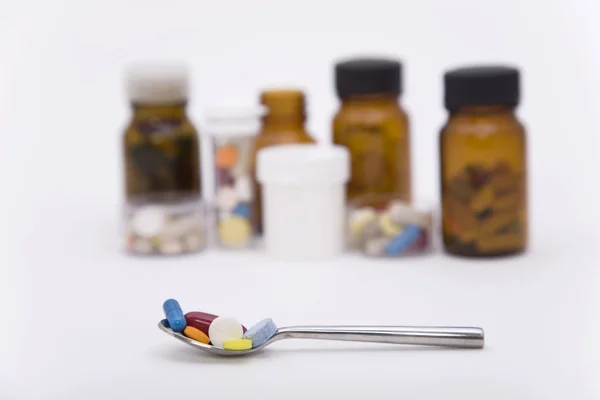 Differently pills in spoon — Zdjęcie stockowe