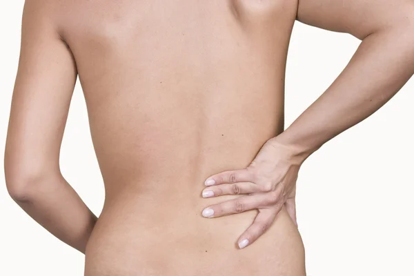 Kvinna massera smärta i nedre tillbaka — Stockfoto