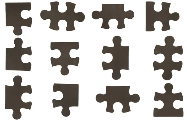 Different black puzzle pieces — Stock Photo, Image