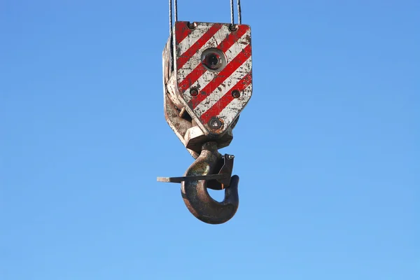 Rusty crane hook and steel cables hanging on blue sky — Stock Photo, Image