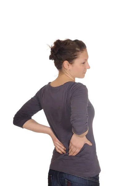 У молодой женщины боли в спине — стоковое фото
