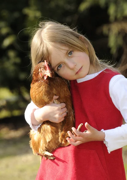Girl hugging a chicken — Stock Photo, Image