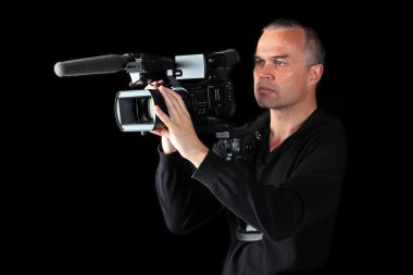 Young male videographer shooting at night or in studio clipart