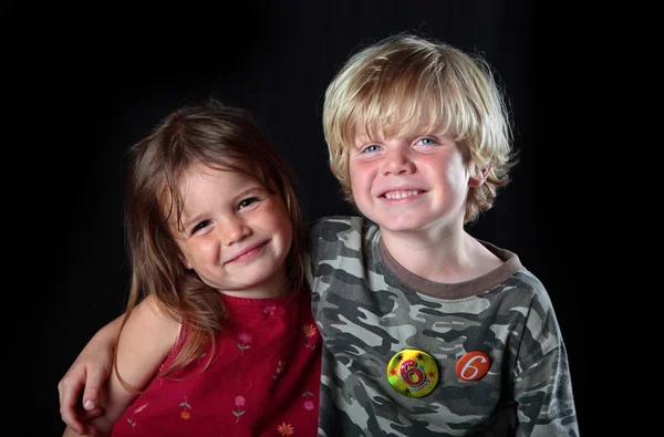 Young boy celebrates his 6th birthday with his sister — Stock Photo, Image
