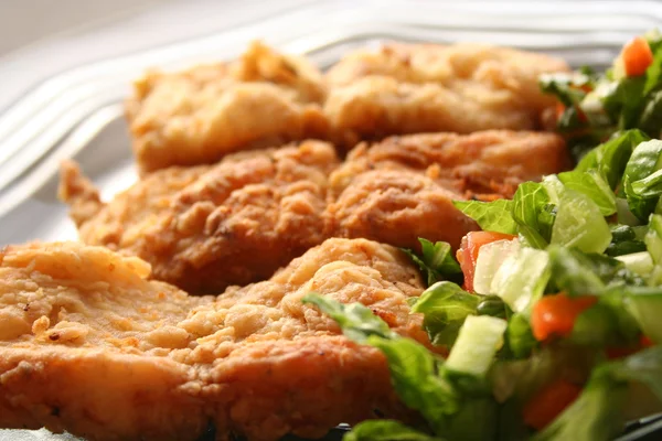 stock image Fried fish fillet in dish with salad