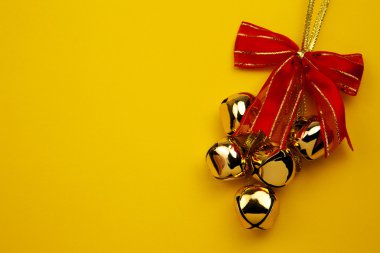 Christmas Bells On The Yellow Background clipart